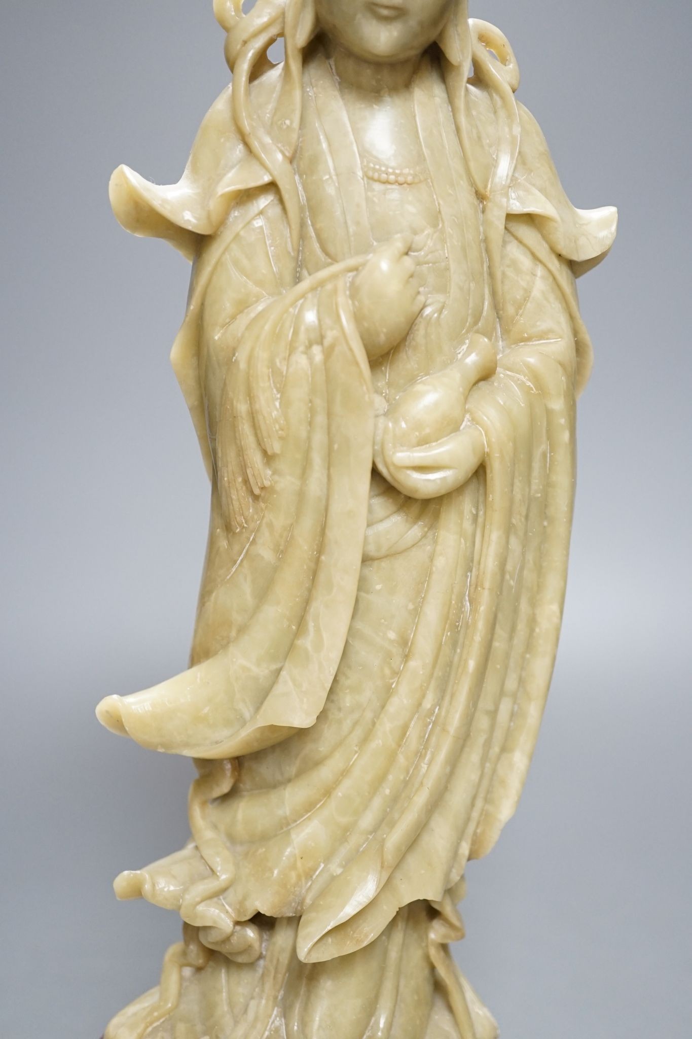 A large Chinese soapstone figure of Guanyin, on base, 40cm